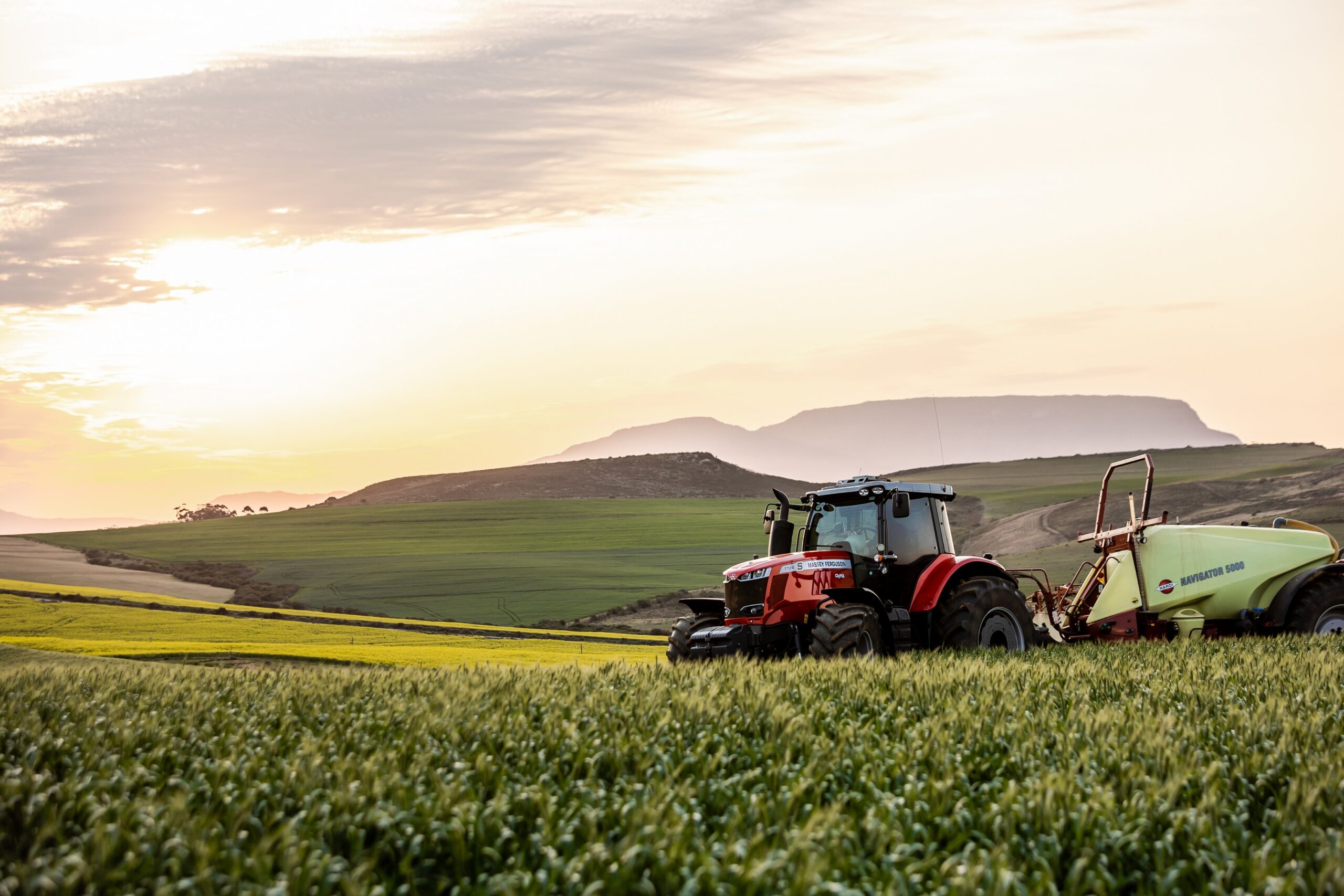 Tractor harvesting across a farm
