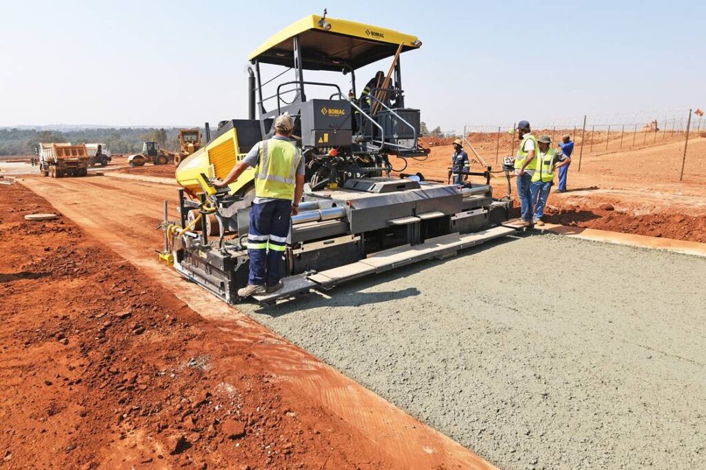 Construction workers paving a road